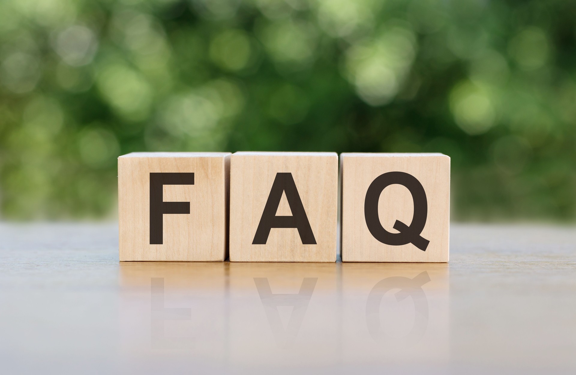 FAQ letter on block cubes on wooden table over blur green tree in park, Frequently asked questions, Business customer service and support concept